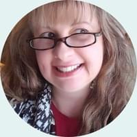 photo of a smiling woman wearing eyeglasses