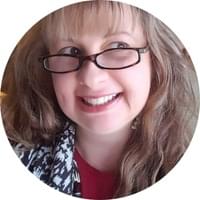 photo of a smiling woman wearing eyeglasses